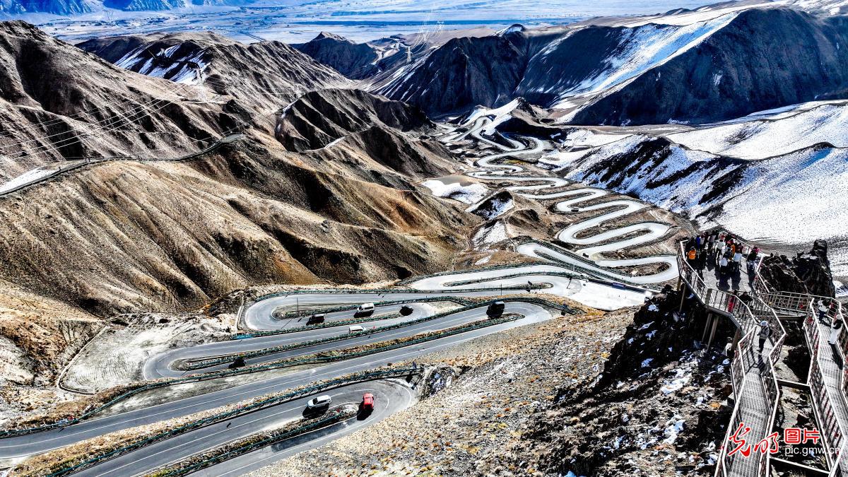 Wider aerial of Panlong switchbacks through mountain landscape