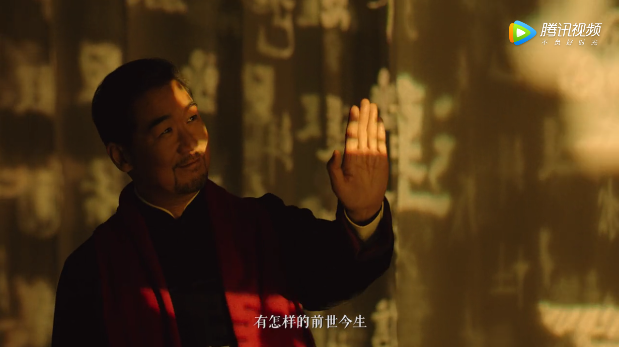 Zhang Guoli touching ancient calligraphy wall