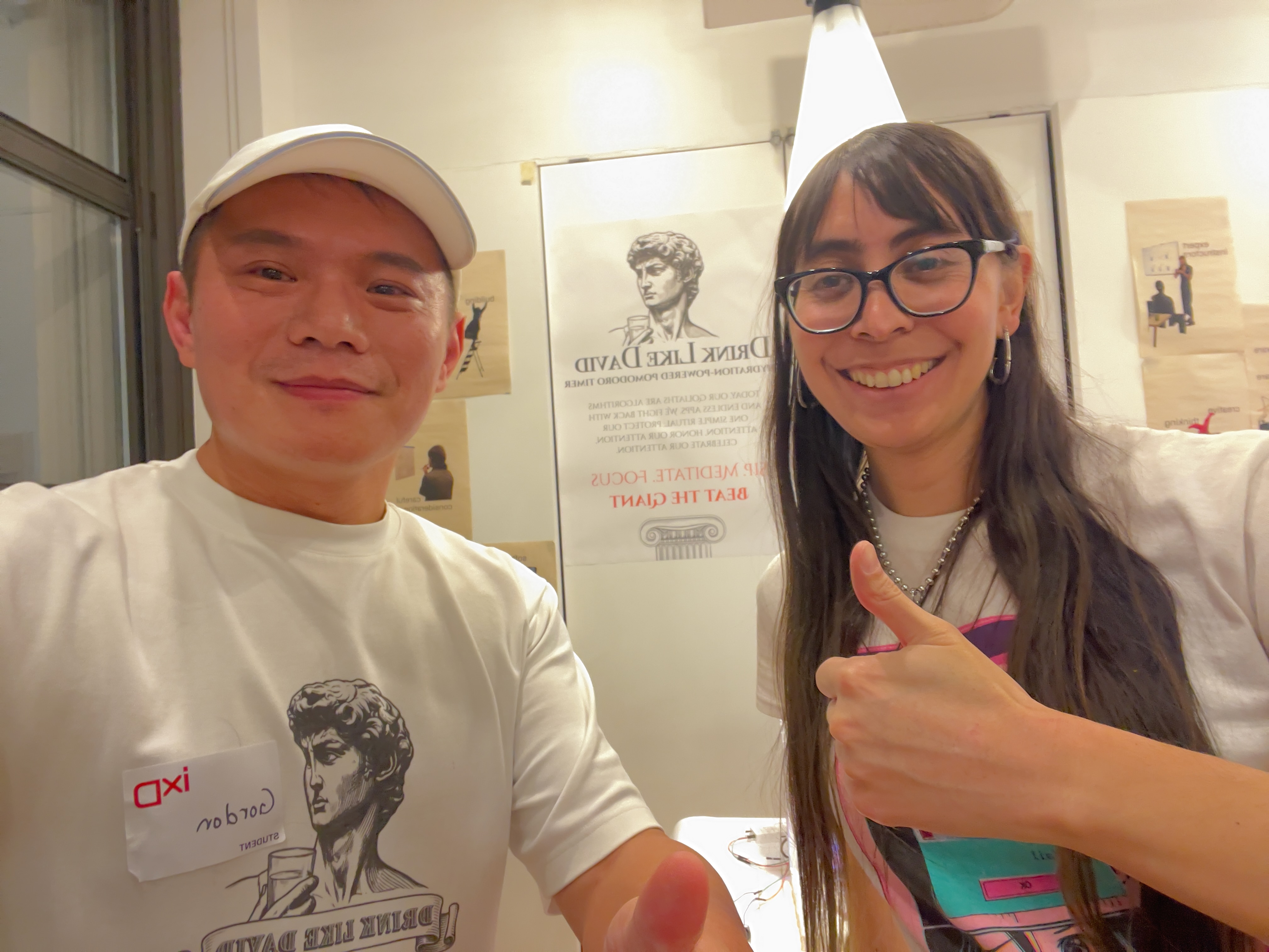 Gordon with classmate at the Drink Like David exhibition booth